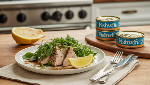 A gourmet kitchen scene with a plated dish featuring smoked albacore tuna and fresh greens, highlighting health-conscious dining.